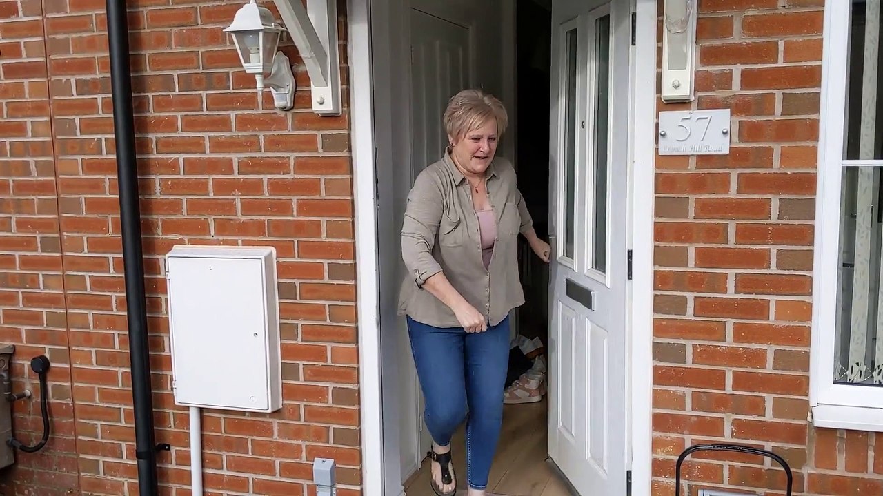 Resident at Crouch Hill Road tries to open and close warped door.