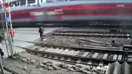Shocking Moment Man Barely Misses Oncoming Train When He Falls Off His Bike