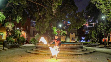 'Fire artist flawlessly juggles a LIT UP Thai Staff '