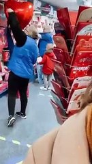 Card Factory shopkeeper helps children pick a Valentine's Day card for their mum