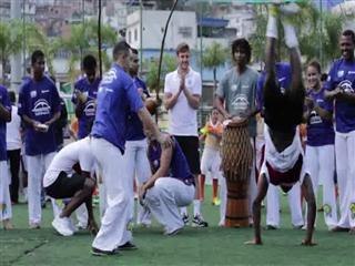 England footballers try out capoeira in Rio's biggest slum
