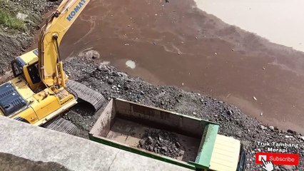 Excavator Dump Truck mining sand and rocks on the river