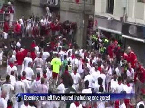 Men vs bulls on slippery cobbled streets of Pamplona