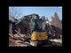 Man Demolishes Old House Using Excavator