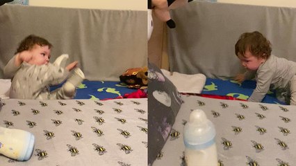 'Adorable baby boy falls off mattress while trying to grab his milk bottle '