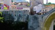 People passing over famous Old Bridge in Mostar, Bosnia and Herzegovina.