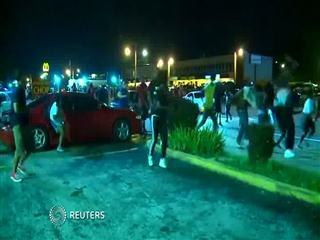 Demonstrators run from police in Ferguson protests