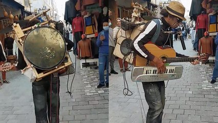 ''One-man band' sings & plays multiple instruments at the SAME TIME'