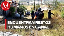 Hallan restos humanos flotando en canal de riego en Michoacán
