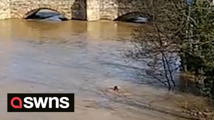 Shocking footage shows boy risking his life by going for a swim in flooded UK river