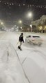 Cops Catch Guy for Snowboarding on Snow Covered City Road