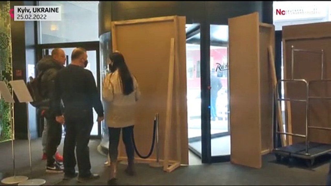 People shelter inside the Radisson Blu hotel in central Kyiv