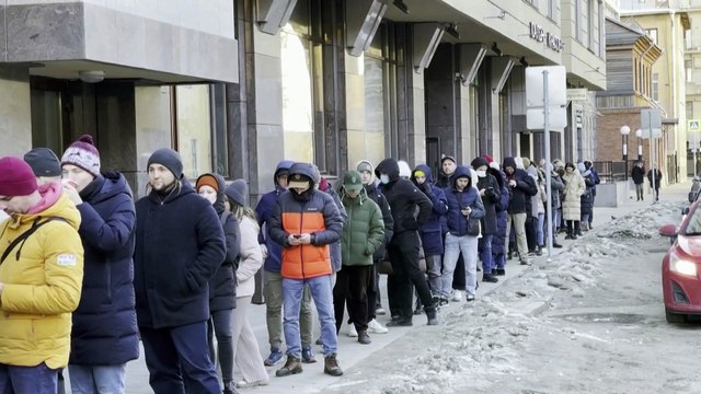 Russians queue to withdraw money amid growing fears about impact of sanctions on economy