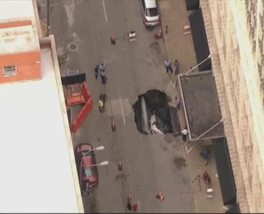 Car swallowed up by large sinkhole