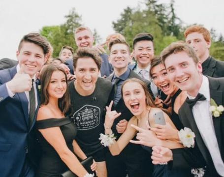 Canadian Prime Minister Justin Trudeau jogs through prom photos