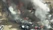Dozens of cars burn as fire sweeps through a parking lot