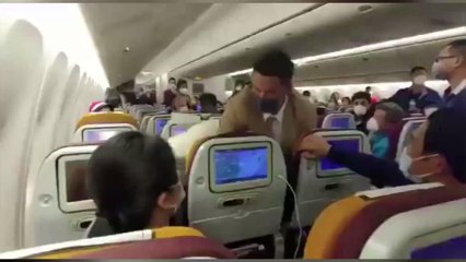 Tensions turn to panic after a woman was tackled by Thai Airways crew after she deliberately coughs on a stewardess