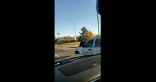Female Driving at High Speeds with Guy on Hood of SUV