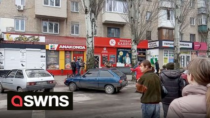 Ukrainian protesters have been filmed shouting at armed Russian soldiers to “go home”