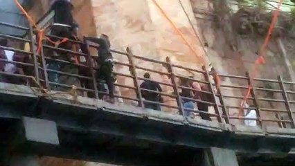 Devotees crossing the bridge dangerously in Omkareshwar