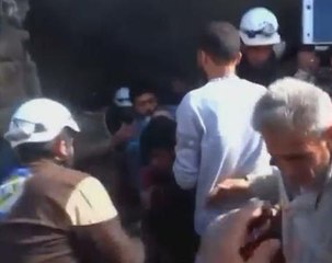 Child rescued from rubble after air strikes in Idlib, Syria