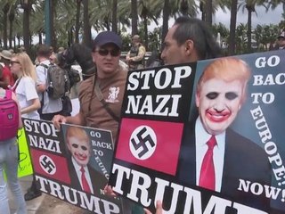Pro and anti-Trump protesters confront each other outside rally