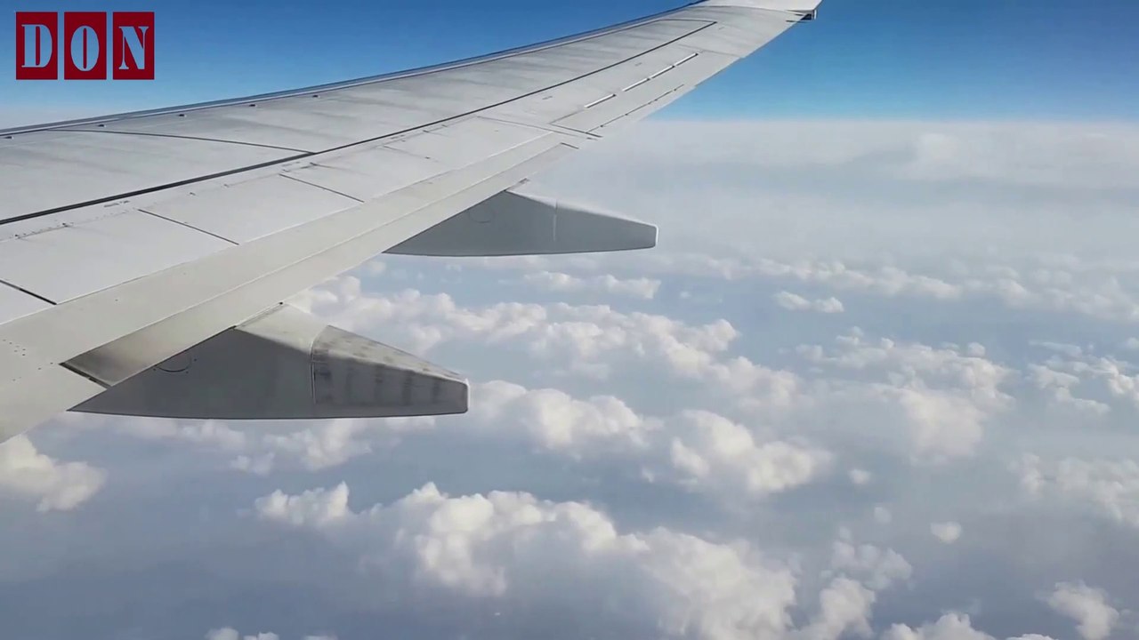 View From An Airplane Window Flying Above The Clouds