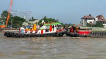 5 tugboats pulling a huge barge at Chao Phraya river in Thailand
