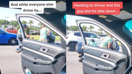 'Compassionate man steps out of his car to help out a motorcycle rider who had dropped his bike '