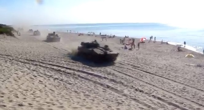 Des chars d’assaut débarquent sur une plage remplie de touristes