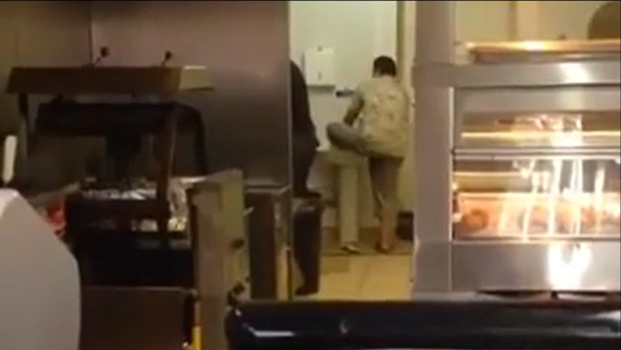 Il filme un homme en train de se laver les pieds dans un évier de fast-food