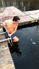 Guy Bumps Head on Ice During Frozen Lake Swim