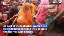 Women 'beat' men with sticks as Holi celebrations kick off in India