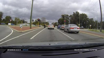 Motorcycle goes through red light in Mandurah.
