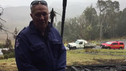 Fire investigators inspect rubble at Cradle Mountain