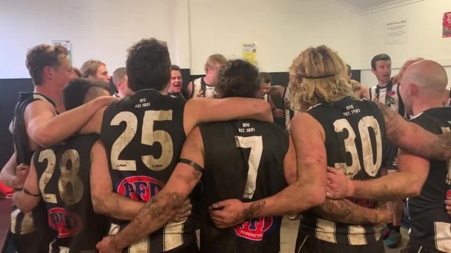 Devonport players singing the club song after their NWFL win over Ulverstone at Devonport Oval