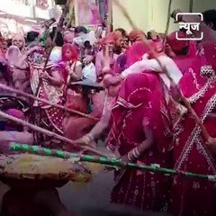 People In Mathura Celebrate Lathmar Holi With Sticks And Flowers