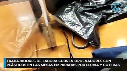 Trabajadores de Labora cubren ordenadores con plásticos en las mesas empapadas por lluvia y goteras