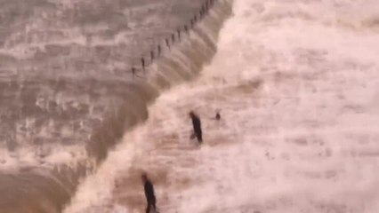 Surfers in the barrel on Newcastle Beach