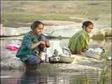 Maldhari women wash clothes by the river