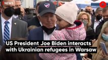 US President Joe Biden interacts with Ukrainian refugees in Warsaw