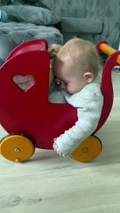 Baby Sleeps in Doll's Stroller