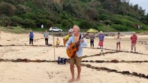 Residents singing out for peace at the peace circle on Broulee Beach on March 29