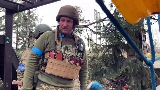 Ukrainian soldiers patrol village near Kyiv they have retaken as Russians claim they are withdrawing from capital