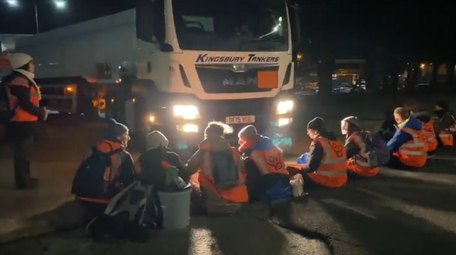 Extinction Rebellion protesters block lorry from the entrance of an oil terminal