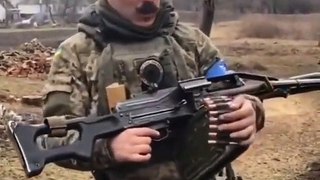 TROPHY MACHINEGUN- Ukrainian soldier displays a Russian PKP machinegun
