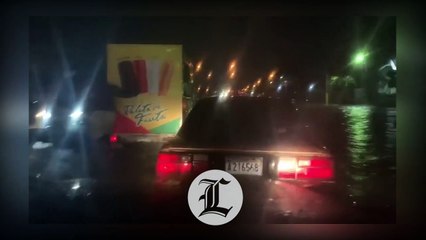 Gran charco de agua en el elevado de la entrada de Los Alcarrizos