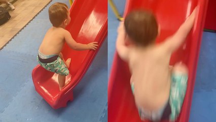'Adventurous toddler tries to walk up a slide *HE COULDN'T MAKE IT!*'