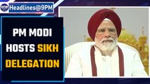 PM Modi hosts Sikh delegation at his Delhi residence; PM wears red turban | Oneindia News