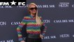 Paris Hilton pairs rainbow top into black mini skirt and tights